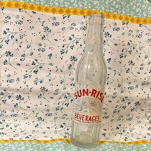 Sun-Rise Beverages Clear Glass Bottle with Red Logo